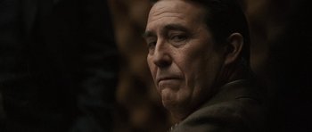 Movie still from “Tinker Tailor Soldier Spy” (2011), directed by Tomas Alfredson – An older man looking into the distance with a serious look; Close Up shot, Over the shoulder angle