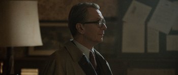 Movie still from “Tinker Tailor Soldier Spy” (2011), directed by Tomas Alfredson – An older man wearing a suit and tie; Close Up shot, Low angle
