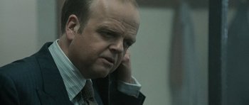 Movie still from “Tinker Tailor Soldier Spy” (2011), directed by Tomas Alfredson – A person talking on a cell phone; Close Up shot, Over the shoulder angle