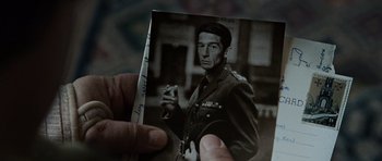 Movie still from “Tinker Tailor Soldier Spy” (2011), directed by Tomas Alfredson – An old photo of a man in uniform holding a cigarette; Extreme Close Up shot, High angle