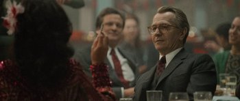 Movie still from “Tinker Tailor Soldier Spy” (2011), directed by Tomas Alfredson – A group of people sitting around a table; Close Up shot, Over the shoulder angle