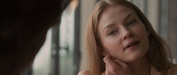 Movie still from “Tinker Tailor Soldier Spy” (2011), directed by Tomas Alfredson – A person with long blonde hair; Close Up shot, Over the shoulder angle