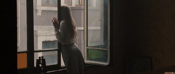 Movie still from “Tinker Tailor Soldier Spy” (2011), directed by Tomas Alfredson – A woman standing in front of an open window; Medium shot, Over the shoulder angle