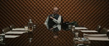 Movie still from “Tinker Tailor Soldier Spy” (2011), directed by Tomas Alfredson – A man sitting at a table in front of a mirror; Medium shot, Over the shoulder angle