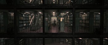 Movie still from “Tinker Tailor Soldier Spy” (2011), directed by Tomas Alfredson – A person is sitting in a room in a library; Extreme Wide shot, High angle