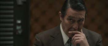 Movie still from “Tinker Tailor Soldier Spy” (2011), directed by Tomas Alfredson – A person wearing a suit and tie; Close Up shot, Over the shoulder angle