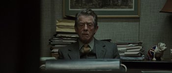 Movie still from “Tinker Tailor Soldier Spy” (2011), directed by Tomas Alfredson – An older man sitting at a computer keyboard; Medium shot, Over the shoulder angle