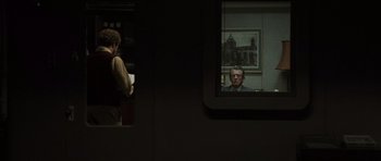 Movie still from “Tinker Tailor Soldier Spy” (2011), directed by Tomas Alfredson – A man is looking at himself in the mirror; Medium shot, Over the shoulder angle