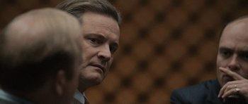 Movie still from “Tinker Tailor Soldier Spy” (2011), directed by Tomas Alfredson – A person wearing a suit and tie; Close Up shot, Over the shoulder angle