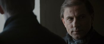 Movie still from “Tinker Tailor Soldier Spy” (2011), directed by Tomas Alfredson – A person looking at the camera; Close Up shot, Over the shoulder angle