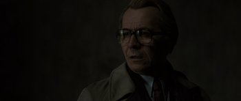 Movie still from “Tinker Tailor Soldier Spy” (2011), directed by Tomas Alfredson – An older man wearing glasses and wearing a coat; Close Up shot, Low angle