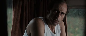 Movie still from “Tinker Tailor Soldier Spy” (2011), directed by Tomas Alfredson – A person wearing a white shirt; Close Up shot, Over the shoulder angle