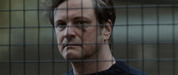 Movie still from “Tinker Tailor Soldier Spy” (2011), directed by Tomas Alfredson – A person behind a wire fence; Close Up shot, Over the shoulder angle