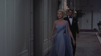 Movie still from “To Catch a Thief” (1955), directed by Alfred Hitchcock – A man and a woman walking down a hallway; Medium shot, Low angle