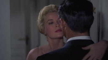 Movie still from “To Catch a Thief” (1955), directed by Alfred Hitchcock – A man and a woman are kissing each other in front of a mirror; Close Up shot, Low angle