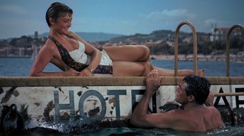 Movie still from “To Catch a Thief” (1955), directed by Alfred Hitchcock – A man and a woman on a boat in the water; Medium shot, High angle