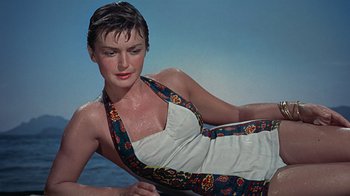 Movie still from “To Catch a Thief” (1955), directed by Alfred Hitchcock – A beautiful woman in a white and blue dress; Medium shot, High angle