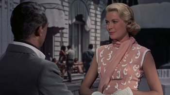 Movie still from “To Catch a Thief” (1955), directed by Alfred Hitchcock – A man and a woman talking in front of a building; Medium shot, Over the shoulder angle
