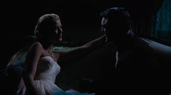 Movie still from “To Catch a Thief” (1955), directed by Alfred Hitchcock – A man and a woman in a dark room; Medium shot, Low angle