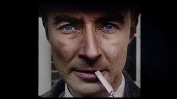 Movie still from “To End All War: Oppenheimer & the Atomic Bomb” (2023), directed by Christopher Cassel – A person smoking a cigarette; Extreme Close Up shot, Overhead angle