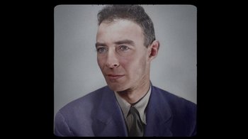 Movie still from “To End All War: Oppenheimer & the Atomic Bomb” (2023), directed by Christopher Cassel – A painting of a man in a suit and tie; Close Up shot, High angle