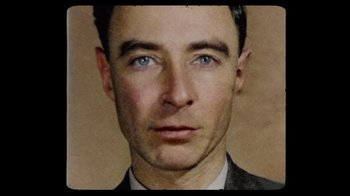 Movie still from “To End All War: Oppenheimer & the Atomic Bomb” (2023), directed by Christopher Cassel – A person wearing a suit and tie; Extreme Close Up shot, Overhead angle