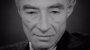 Movie still from “To End All War: Oppenheimer & the Atomic Bomb” (2023), directed by Christopher Cassel – An older man wearing a suit and tie; Extreme Close Up shot, High angle