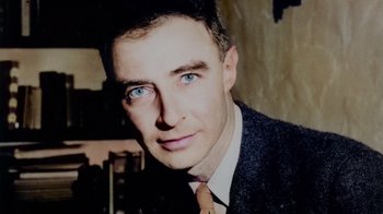 Movie still from “To End All War: Oppenheimer & the Atomic Bomb” (2023), directed by Christopher Cassel – A person wearing a suit and tie; Extreme Close Up shot, High angle