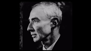 Movie still from “To End All War: Oppenheimer & the Atomic Bomb” (2023), directed by Christopher Cassel – An older man wearing a suit and tie looking to his left; Close Up shot, Low angle