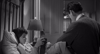Movie still from “To Kill a Mockingbird” (1962), directed by Robert Mulligan – A man and a boy sitting in front of a window; Medium shot, High angle