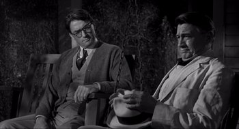 Movie still from “To Kill a Mockingbird” (1962), directed by Robert Mulligan – Two men sitting next to each other on a swing; Medium shot, Over the shoulder angle