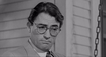 Movie still from “To Kill a Mockingbird” (1962), directed by Robert Mulligan – An old photo of a man in a suit and glasses; Close Up shot, Over the shoulder angle