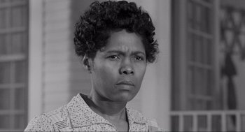 Movie still from “To Kill a Mockingbird” (1962), directed by Robert Mulligan – An old black and white photo of a woman with curly hair; Close Up shot, Low angle