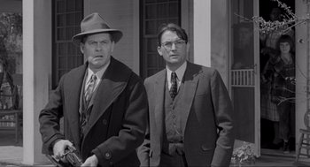 Movie still from “To Kill a Mockingbird” (1962), directed by Robert Mulligan – A black and white photo of two men standing next to each other; Medium shot, Low angle