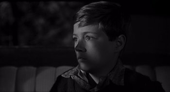 Movie still from “To Kill a Mockingbird” (1962), directed by Robert Mulligan – A young boy sitting in front of a window; Close Up shot, High angle