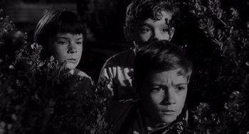 Movie still from “To Kill a Mockingbird” (1962), directed by Robert Mulligan – A group of young boys standing next to each other; Medium shot, High angle