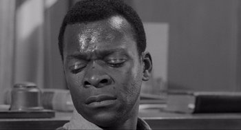 Movie still from “To Kill a Mockingbird” (1962), directed by Robert Mulligan – A black and white photo of a man with his eyes closed; Close Up shot, High angle