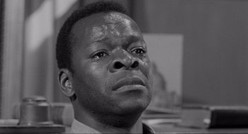 Movie still from “To Kill a Mockingbird” (1962), directed by Robert Mulligan – A black and white photo of a man looking up at the sky; Close Up shot, Over the shoulder angle