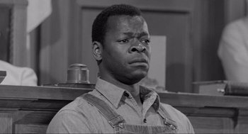 Movie still from “To Kill a Mockingbird” (1962), directed by Robert Mulligan – A black and white photo of a man with a sad look; Close Up shot, Low angle