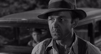 Movie still from “To Kill a Mockingbird” (1962), directed by Robert Mulligan – A black and white photo of a man wearing a hat; Close Up shot, Low angle