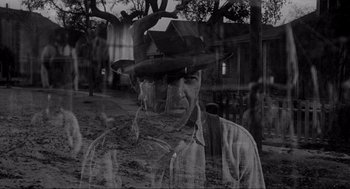 Movie still from “To Kill a Mockingbird” (1962), directed by Robert Mulligan – An old photo of a man in a cowboy hat; Medium shot, Over the shoulder angle