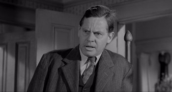 Movie still from “To Kill a Mockingbird” (1962), directed by Robert Mulligan – A man in a suit and tie in a room; Close Up shot, Over the shoulder angle