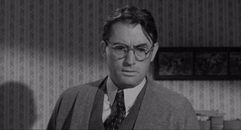 Movie still from “To Kill a Mockingbird” (1962), directed by Robert Mulligan – A man in a suit and tie wearing glasses and a tie; Close Up shot, Over the shoulder angle