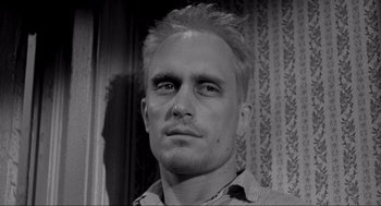 Movie still from “To Kill a Mockingbird” (1962), directed by Robert Mulligan – Black and white photograph of a man's face in front of a wall; Close Up shot, Low angle