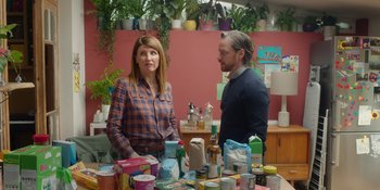 Movie still from “Together” (2021), directed by Justin Martin – A man and a woman standing in front of a table full of food; Medium shot, Over the shoulder angle