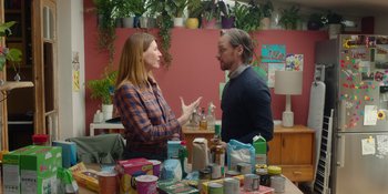 Movie still from “Together” (2021), directed by Justin Martin – A man and a woman talking in front of a pile of food; Medium shot, Over the shoulder angle