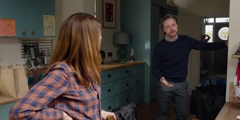 Movie still from “Together” (2021), directed by Justin Martin – A man and a woman are standing in front of a mirror; Medium shot, Over the shoulder angle