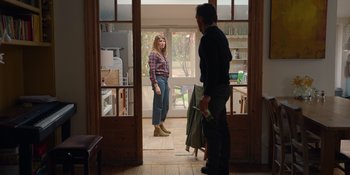 Movie still from “Together” (2021), directed by Justin Martin – A man and a woman standing in front of an open door; Wide shot, Over the shoulder angle