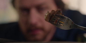 Movie still from “Together” (2021), directed by Justin Martin – A fork with a piece of food on it; Extreme Close Up shot, High angle