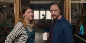 Movie still from “Together” (2021), directed by Justin Martin – A man and a woman standing next to each other holding a cup; Medium shot, Low angle